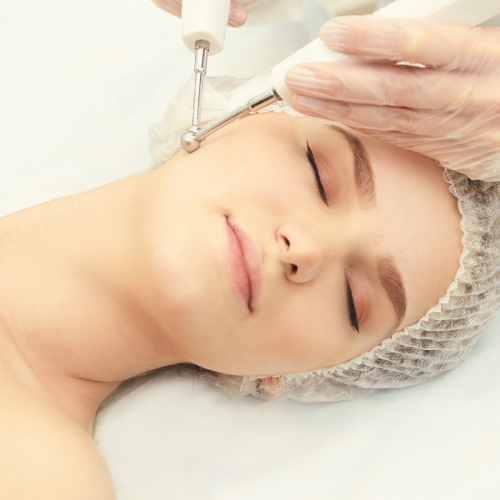 Woman receiving high frequency facial treatment